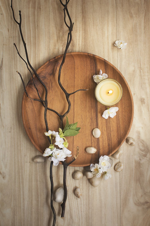 Flat lay candle, brunches, pebble stones
