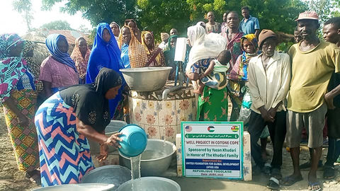 "Immerse yourself in the essence of Togo with this captivating image. A local woman, her face illuminated by a radiant smile, pours life-giving water from a newly inaugurated well into jugs. The grand opening ceremony captures the heart of UFGD.org's mission, as we stand united with the community, empowering them with access to clean water. This snapshot embodies the resilience and shared aspirations that define Togo, reflecting the positive change that our collaborative efforts are igniting."