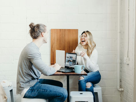 Two people having covvee and laughing