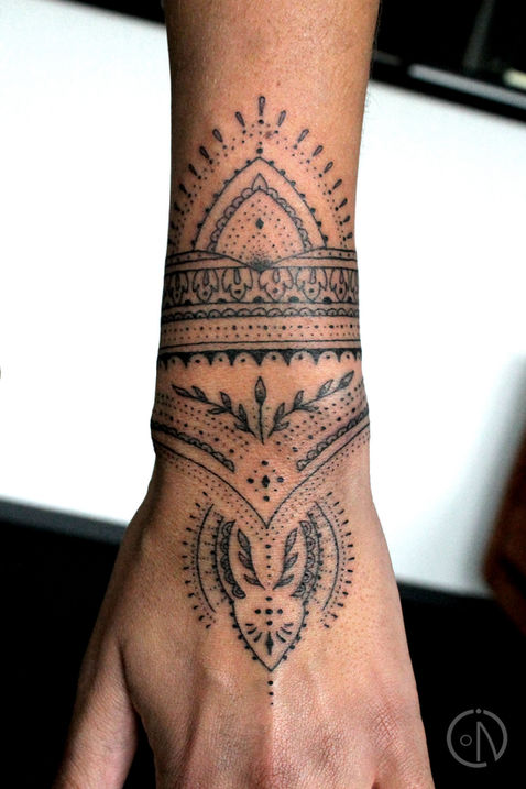 Ornamental fine lines wrist tattoo