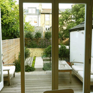 Looking through open doors from a house into a garden 