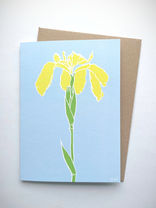 pale blue greeting card featuring contemporary yellow iris flower design, with brown kraft paper envelope
