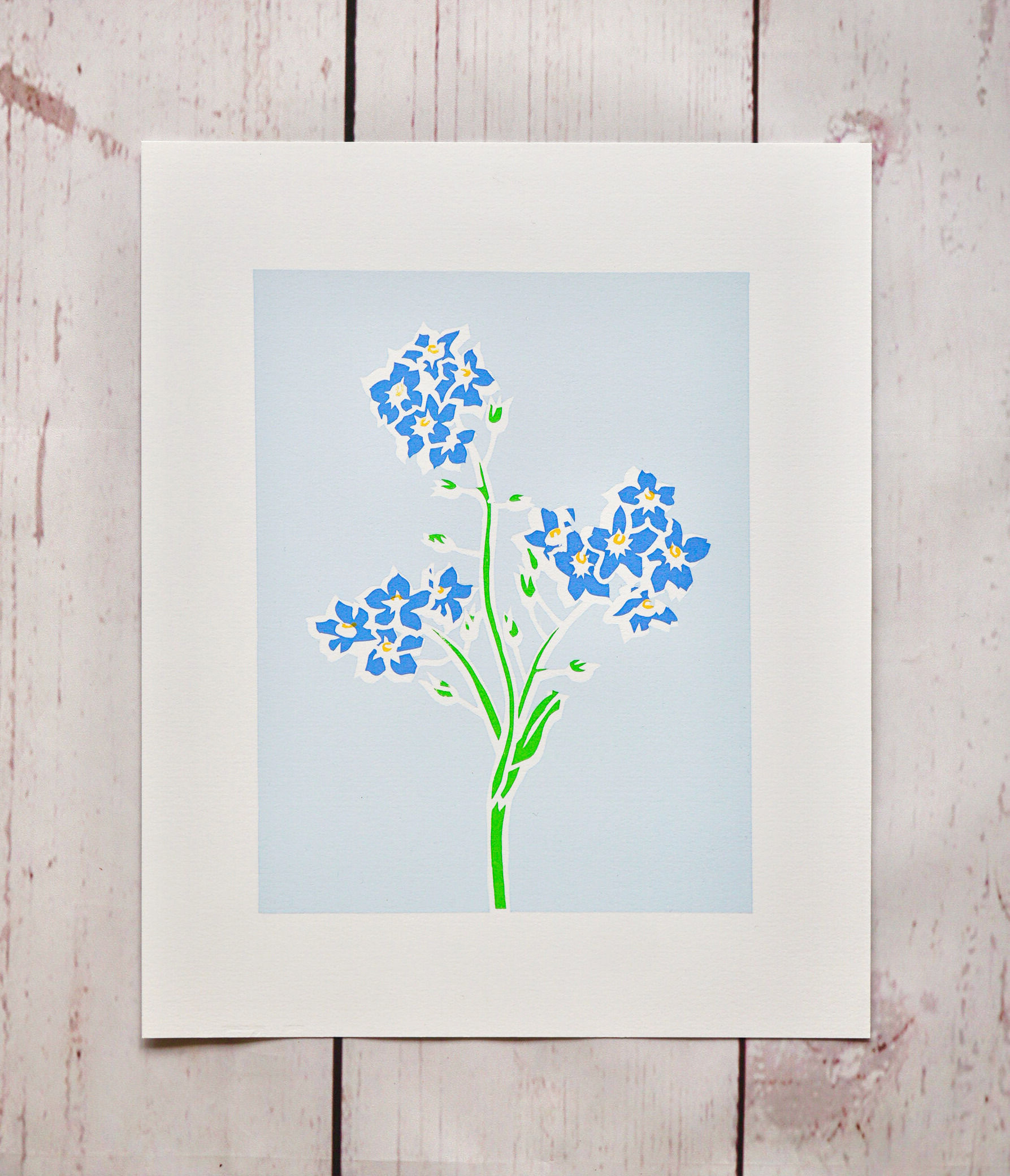 forget me not art print of blue forget me not flowers on a single green stem against a pale blue background