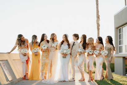 Bride and her entourage captured in a joyful wedding day portrait