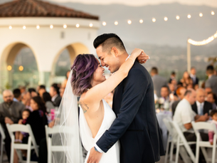 Bride and groom embrace at outdoor wedding with string lights, guests seated nearby. Text: Sunset Love among the Moxi Museum, August 2019.