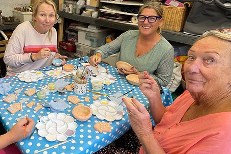 Glazing bowls - hand thrown on the Pottery wheel and beach huts. Ceramic Class.