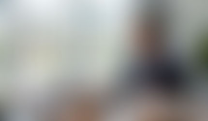 a female professional property manager or accountant reviewing property financial reports on a laptop 