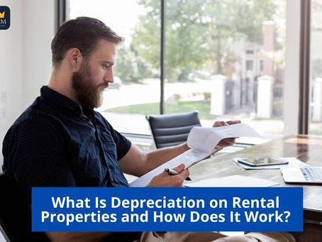 A landlord or property manager reviewing financial reports with rental property documents on the table.
