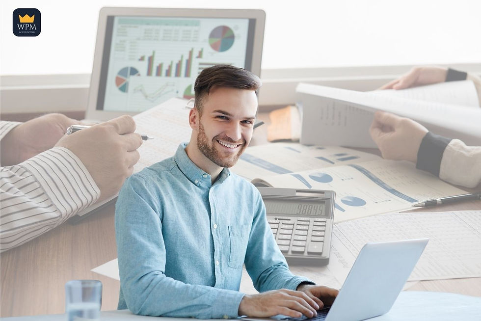 A property manager working at a clean desk with a laptop showing financial dashboards