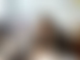 A professional female property manager sitting at her modern office desk, looking at a computer screen showing Monday.com dashboards