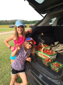 The girls showing off their “biggest pick” and our bounty.