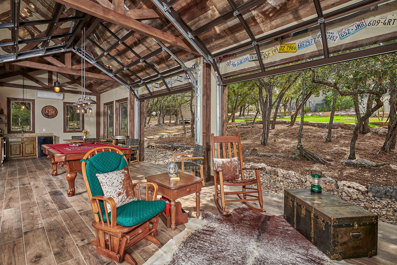 Two large glass garage doors opened for ventilation and serene views.