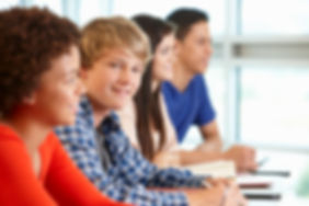 Multi-racial-teenage-pupils-in-class,-on