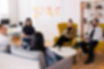 team sitting around leader, listening, learning, millenials