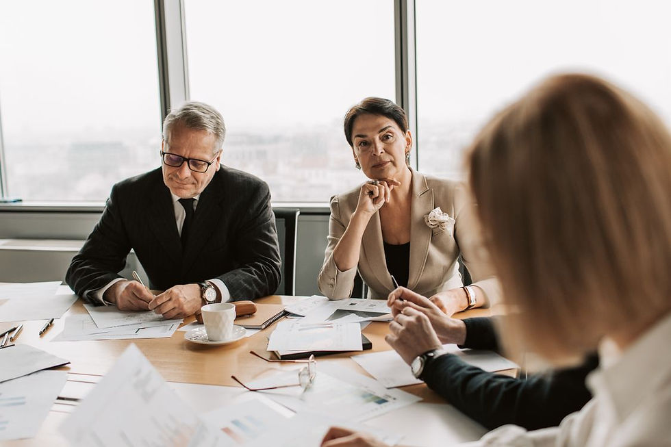 Business professionals reviewing information around a meeting table