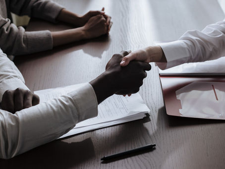 HOA board representative and vendor shaking hands over a service contract