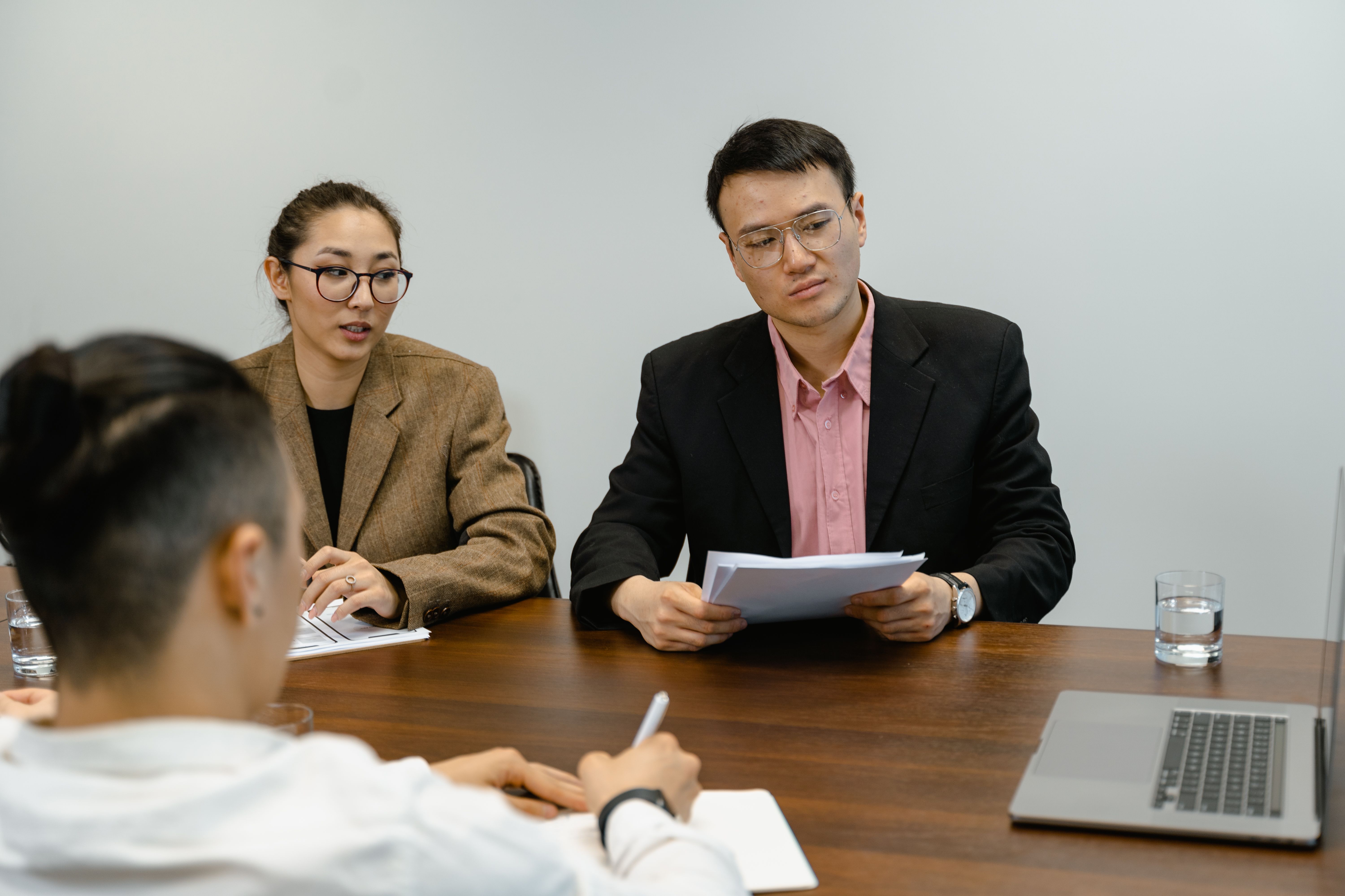 Board members reviewing association documents during an office meeting
