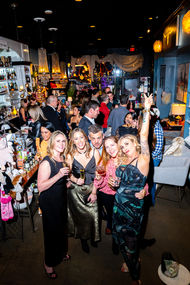 Group of friends celebrating at a crowded indoor event.