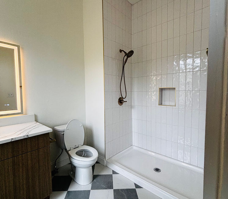 Modern bathroom with checkered floor and tile shower