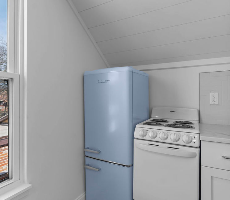 Kitchen with blue retro fridge and white stove