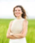 White female therapist with beach grass in background.