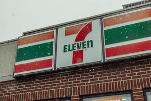 The 7 Eleven sign on the front of the Mobil gas station convenience store in elkhart, indiana.