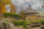 The herb garden and a common backdrop for wedding ceremonies at Fernwood, with a circular stone building surrounded by bushes.