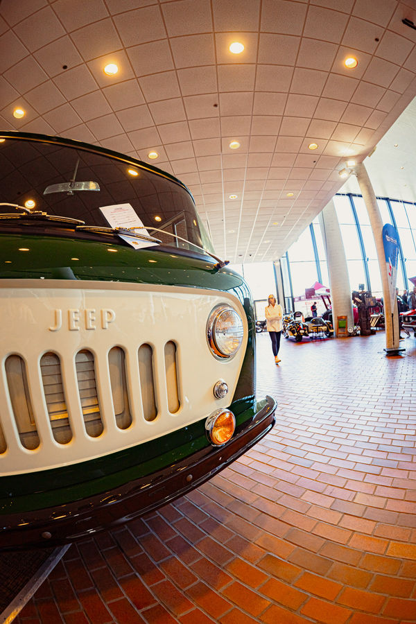 Vintage jeep truck on display in front of the large windows at the century center.