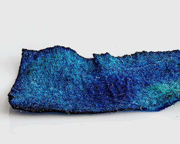 A swatch color of blue dye on a piece of paper towel.