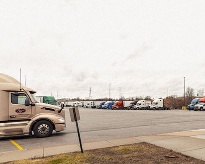 Semi truck parking area at Love’s Travel Stop in Goshen, Indiana, showing multiple parked trucks in the large designated lot.