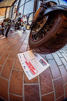 Low view of a motorcycle entry at the south bend car show, with large windows in the background a the south bend century center.