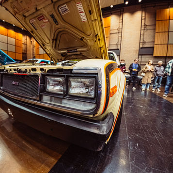 Front view of classic El Camino with hood open and grille detail inside Century Center exhibition hall