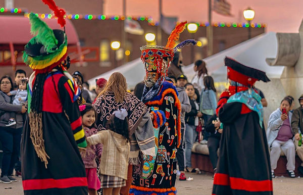 Mexican performance with costumes and guests dancing at sunset at civic plaza in Elkhart, Indiana.