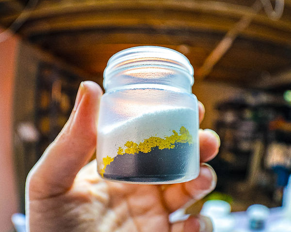 Small plastic shaker bottle containing three colors of Procion fiber reactive dye powder for ice dyeing.