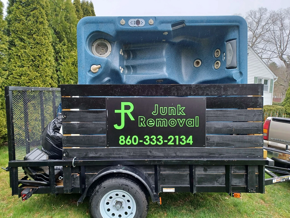 Hot tub being removed by a JR Junk Removal Trailer