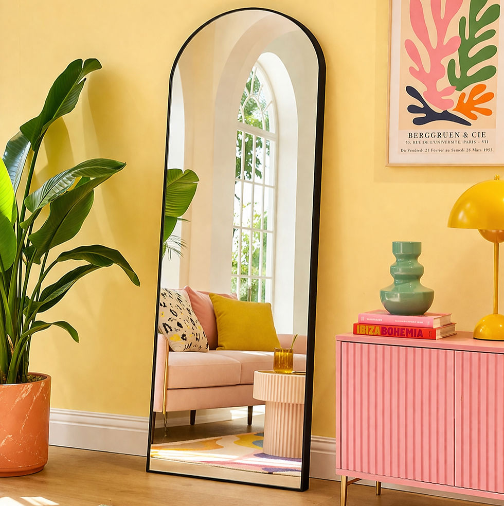 A stylish hallway is enhanced by a full-length statement mirror, reflecting a cozy seating area with vibrant decor and plants, complemented by a colorful rug and artwork.