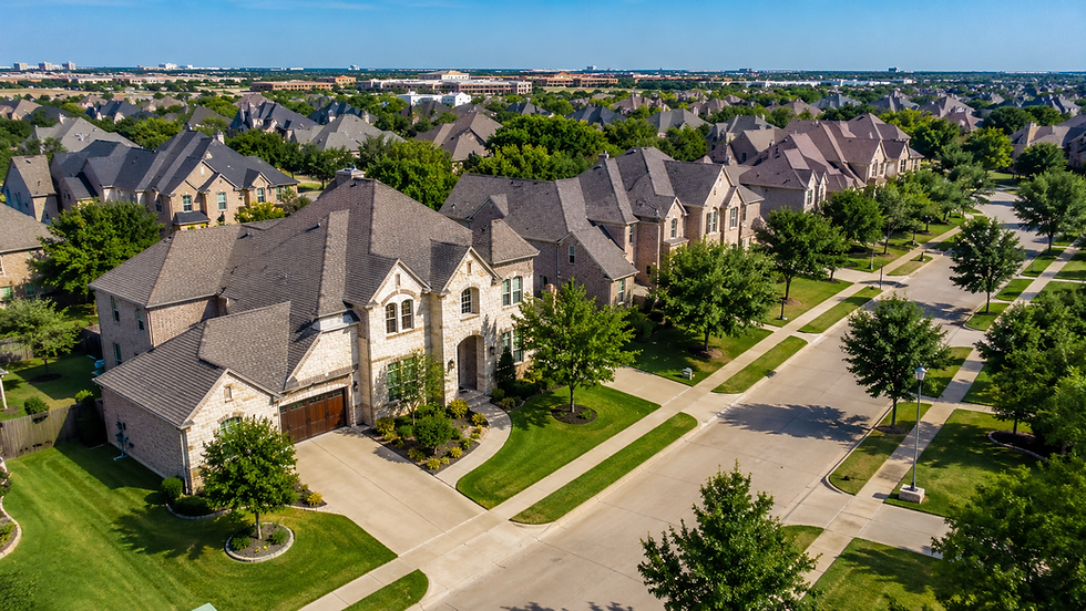 Aerial view of a tree-lined Frisco, Texas neighborhood with upscale homes and sunny suburban streets served by Anywhere Movers.