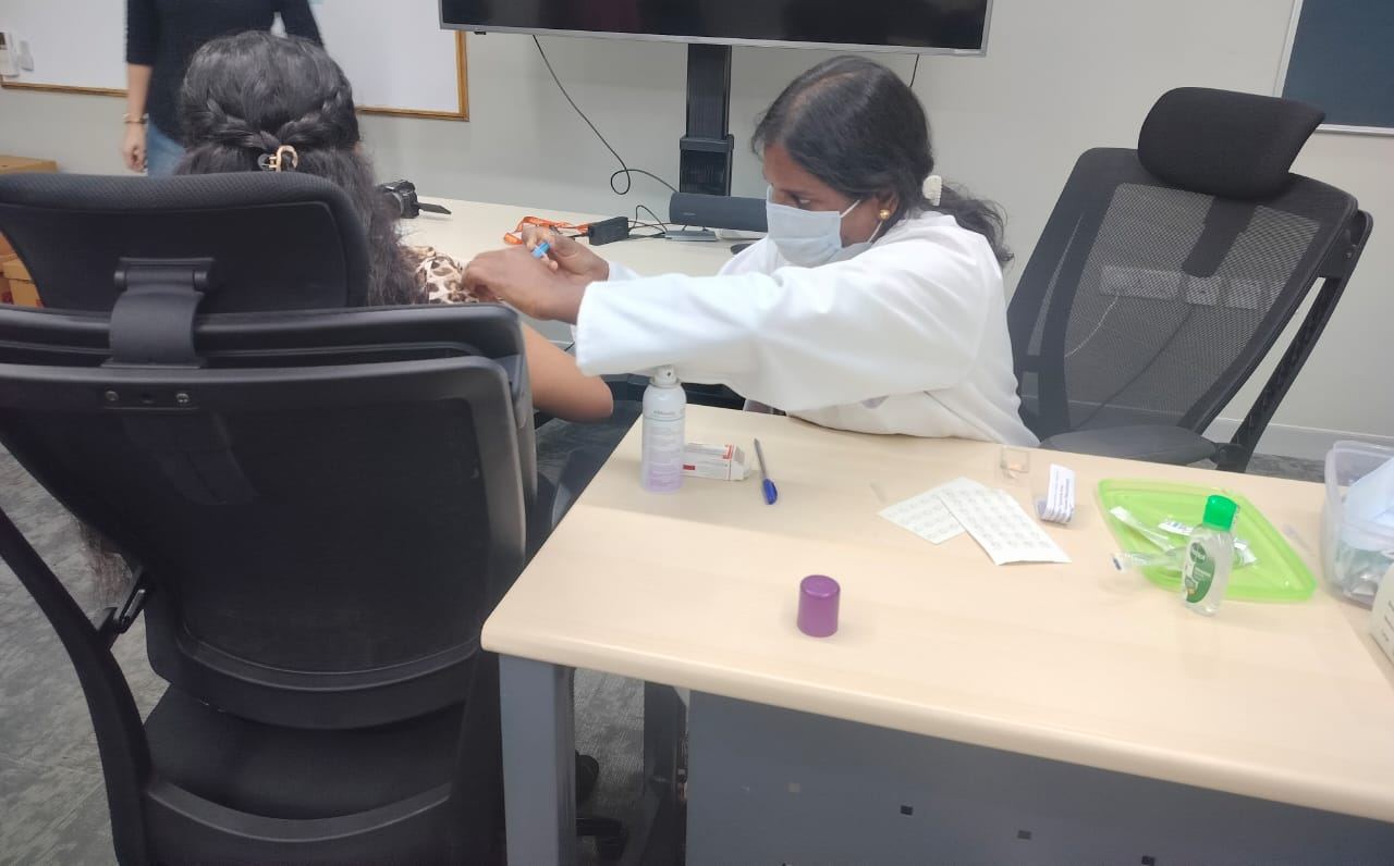 Nurse giving a vaccine at a desk