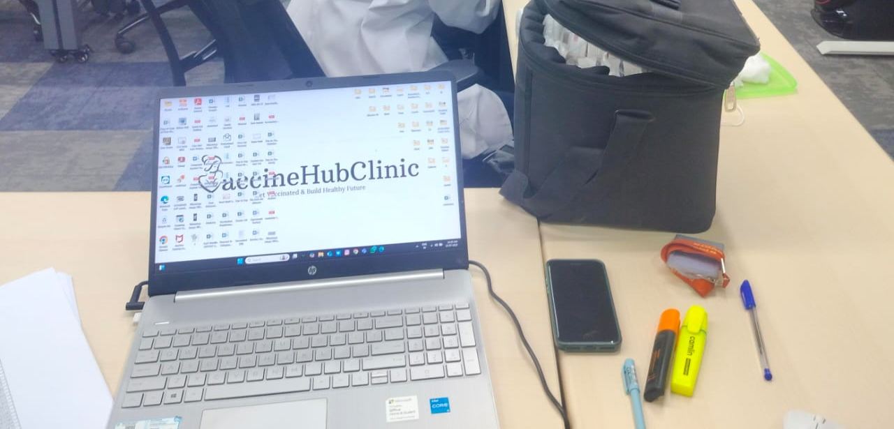 Insulated vaccine box and registration laptop at a drive