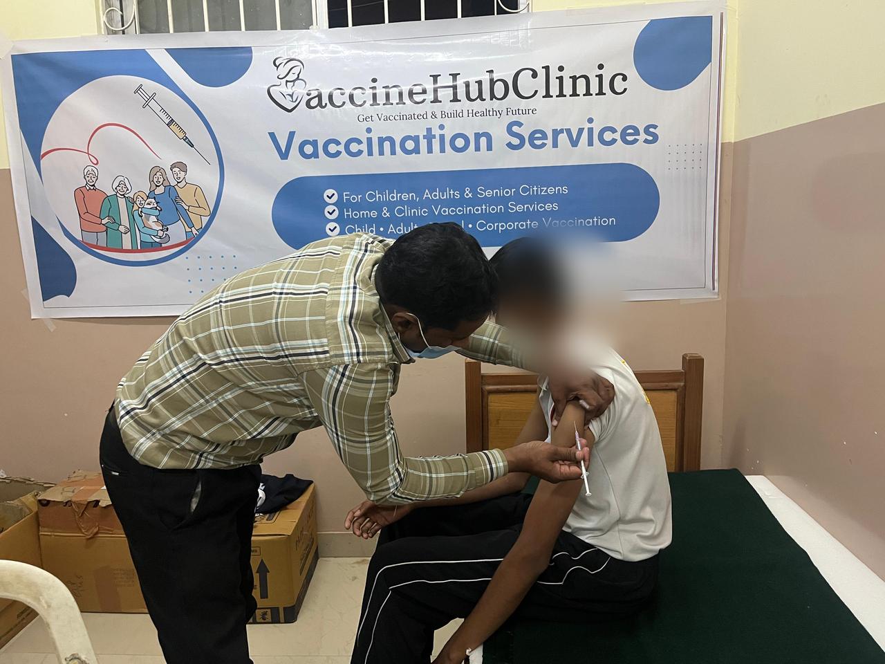 Vaccination camp with Vaccine Hub Clinic banner