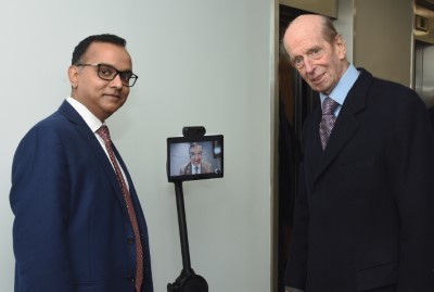 HRH The Duke of Kent with Mayank Prakash FBCS, President of BCS, The Chartered Institute for IT and robot with Rashik Parmar MBE, Group CEO of BCS on screen