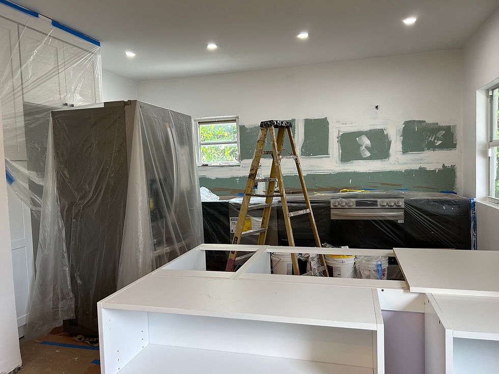 kitchen renovation with ladder and plastic covering over custom quartz countertop