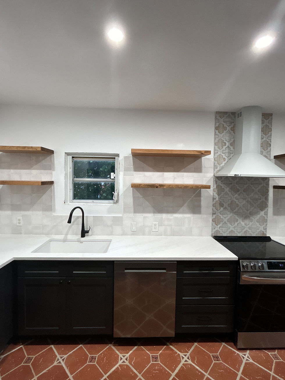 kitchen with white tile backsplash and black faucet with wood shelving 
