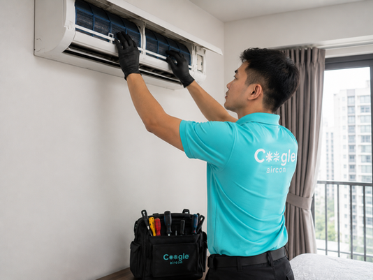 Professional aircon technician carrying out aircon servicing in a Singapore HDB flat — complete guide to aircon service Singapore 2026