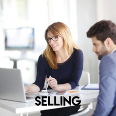 Two business people looking at a computer in an office.