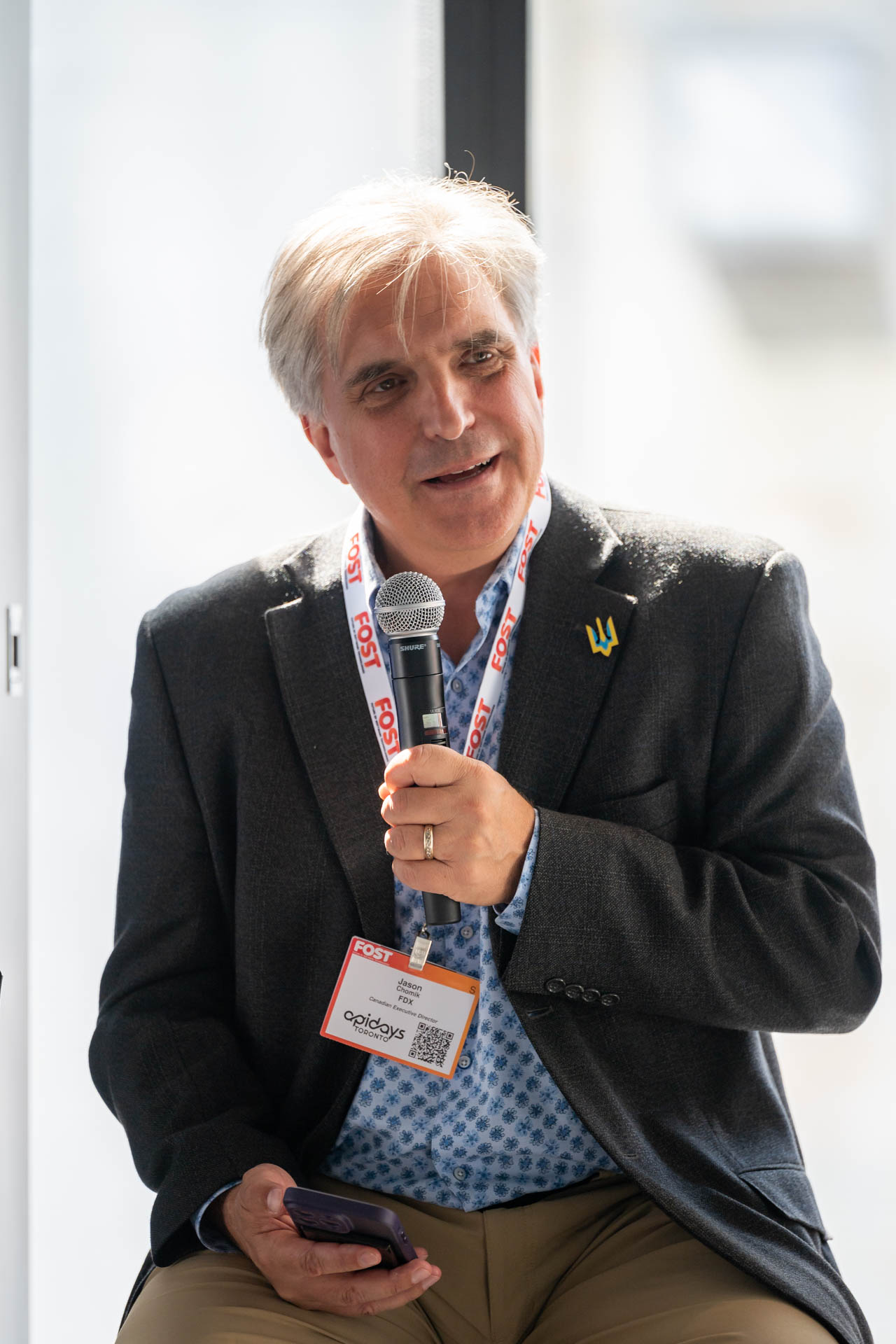 Man speaking into a microphone at an event