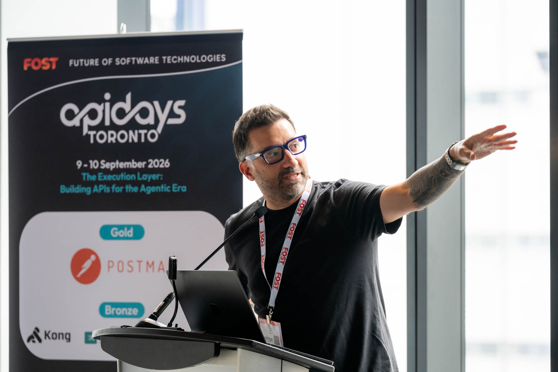 Speaker at Apidays Toronto event presenting from a podium.