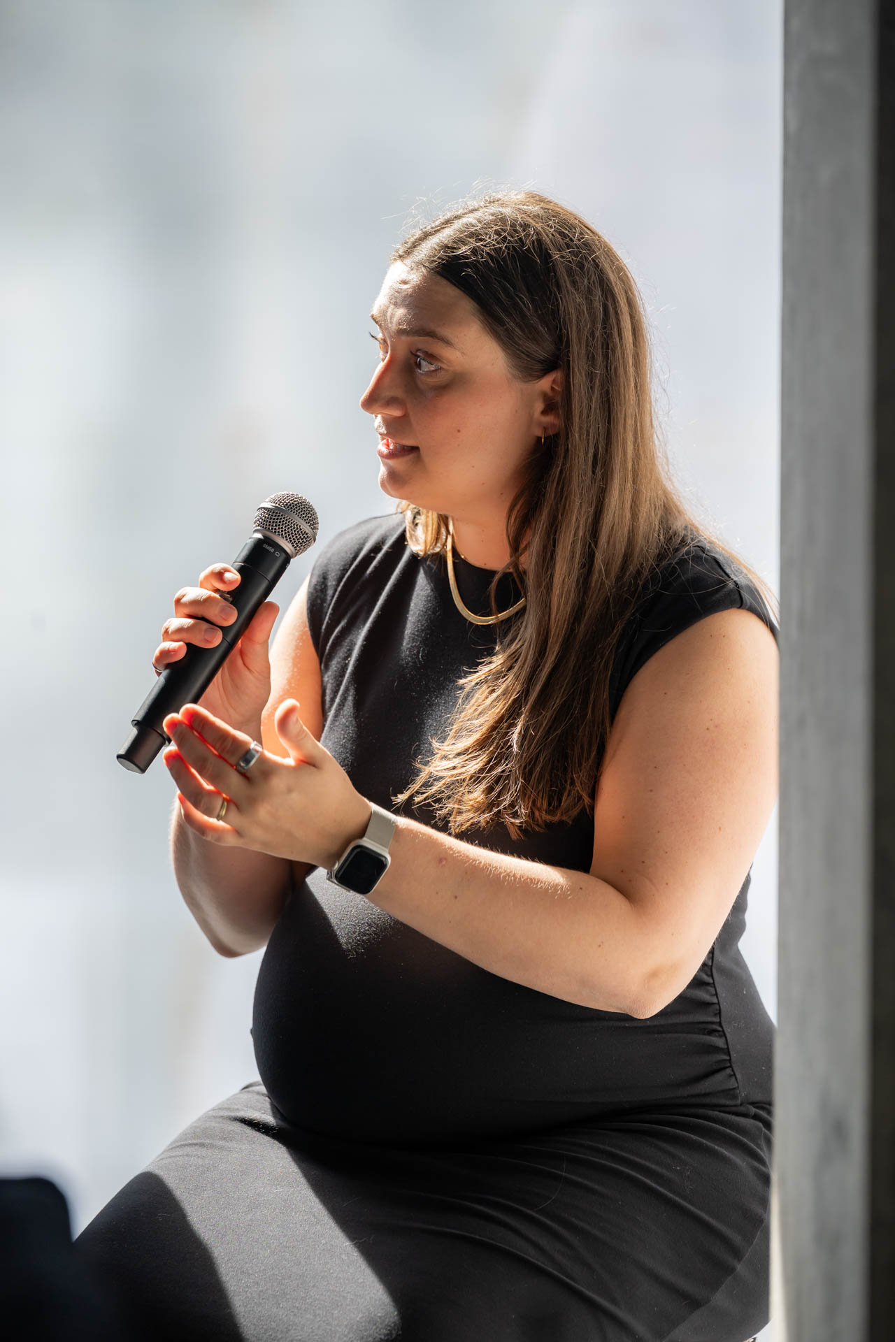 Woman speaking into a microphone at an event