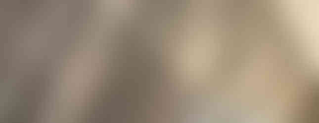 Installer checking alignment of gray vinyl planks to ensure a perfect finish