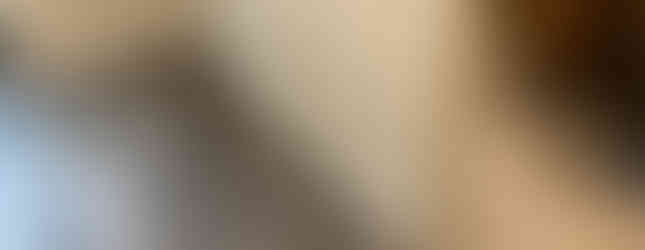 Installation team working on laying gray vinyl planks in a contemporary interior